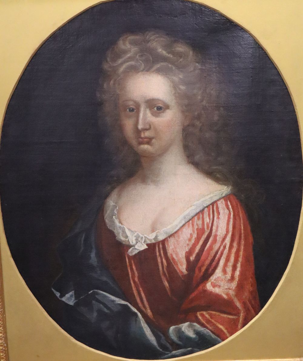 Early 18th century English School, oil on canvas, Portrait of a woman wearing a red dress, framed to the oval, 74 x 60cm